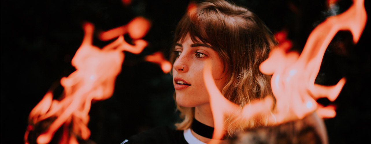 Burning world news. Photo by Matheus Bertellinewspaper-burning-in-hands-of-young-woman-13871563